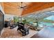 Large screened patio with brick flooring, wood ceiling, ceiling fan and a view of the pool at 1930 Country Club Rd, Eustis, FL 32726
