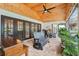 Inviting screened patio with brick flooring, wood ceiling, ceiling fan and comfortable seating at 1930 Country Club Rd, Eustis, FL 32726