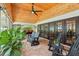 Covered patio featuring a vaulted wood ceiling, ceiling fan, brick floors and comfortable seating at 1930 Country Club Rd, Eustis, FL 32726