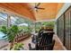 Spacious screened patio with brick flooring, wood ceiling, ample seating and view of pool at 1930 Country Club Rd, Eustis, FL 32726
