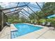Relaxing screened-in pool area with lounge chairs and clear blue water for outdoor enjoyment at 1930 Country Club Rd, Eustis, FL 32726