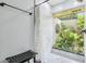 Bright walk-in shower area with tiled walls and garden view at 1930 Country Club Rd, Eustis, FL 32726