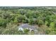 Aerial view of house surrounded by lush greenery at 19703 Lake Lincoln Ln, Eustis, FL 32736