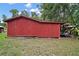 Side view of red barn and storage area at 19703 Lake Lincoln Ln, Eustis, FL 32736