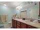 Well-lit bathroom featuring a double sink vanity, large mirror, and neutral wall color at 19703 Lake Lincoln Ln, Eustis, FL 32736