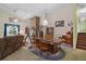 Open-concept dining room with stone fireplace, chandelier, and seating for six at 19703 Lake Lincoln Ln, Eustis, FL 32736