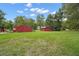 Multiple red barns for equipment storage on beautiful green property at 19703 Lake Lincoln Ln, Eustis, FL 32736
