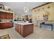 Spacious kitchen with an island, tiled floors, and wood cabinetry at 19703 Lake Lincoln Ln, Eustis, FL 32736