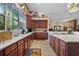 Open kitchen with wood cabinets, white countertops, and breakfast bar at 19703 Lake Lincoln Ln, Eustis, FL 32736