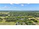 Large acreage property including lush trees and pond. Property line shown at 19703 Lake Lincoln Ln, Eustis, FL 32736
