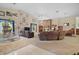 Spacious living room with stone fireplace, vaulted ceilings, and comfortable seating arrangement at 19703 Lake Lincoln Ln, Eustis, FL 32736