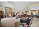 Expansive living room boasts a stone fireplace, vaulted ceilings, and open floor plan at 19703 Lake Lincoln Ln, Eustis, FL 32736