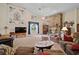 Open living room with stone fireplace, plush seating, and bright natural light at 19703 Lake Lincoln Ln, Eustis, FL 32736