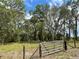 Gated property with established pasture and granddaddy oaks is awaiting your dream home at 19703 Lake Lincoln Ln, Eustis, FL 32736