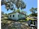 View of the back exterior of the house, showing the siding, windows, and yard at 2001 Bates Ave, Eustis, FL 32726
