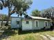 Rear exterior view of the home, showing the siding and yard at 2001 Bates Ave, Eustis, FL 32726