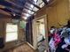 Damaged bedroom interior featuring a ruined ceiling and exposed framework, displaying the need for extensive repairs at 2001 Bates Ave, Eustis, FL 32726