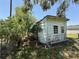 Side view of dilapidated single story home with light blue siding needing repairs at 2001 Bates Ave, Eustis, FL 32726