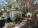 Home's side exterior features a wooden deck, nestled among trees and vegetation at 2001 Bates Ave, Eustis, FL 32726