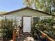 Charming house facade with a wooden ramp entrance, surrounded by greenery at 2001 Bates Ave, Eustis, FL 32726