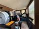 Cluttered room with personal items, furniture, and visible wiring at 2001 Bates Ave, Eustis, FL 32726