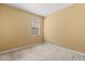 A cozy bedroom featuring neutral carpet and a window providing natural light at 2064 Rafton Rd, Apopka, FL 32703