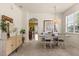 Open dining area with elegant chandelier and view into the kitchen and featuring neutral color palettes at 2064 Rafton Rd, Apopka, FL 32703
