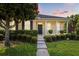 Charming home featuring a manicured front yard, lush landscaping, and a welcoming entrance at 2064 Rafton Rd, Apopka, FL 32703
