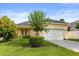 Charming one-story home featuring a well-manicured lawn and a two-car garage at 2064 Rafton Rd, Apopka, FL 32703