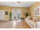 Bright living room features neutral tones, tile flooring, patio door, and comfortable seating with an area rug at 2064 Rafton Rd, Apopka, FL 32703