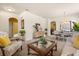 Bright living room flowing into the dining area, featuring an elegant chandelier and stylish decor at 2064 Rafton Rd, Apopka, FL 32703