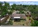 Aerial view of the home featuring a screened patio and tree coverage at 209 Edgewood Dr, Clermont, FL 34711