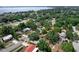 Wide aerial view of the community featuring many mature trees and lake in background at 209 Edgewood Dr, Clermont, FL 34711