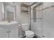 Bathroom featuring an upgraded glass shower, white vanity, and brushed gold finishes at 209 Edgewood Dr, Clermont, FL 34711