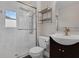Bathroom featuring an upgraded glass shower, dark wood vanity, and brushed gold finishes at 209 Edgewood Dr, Clermont, FL 34711