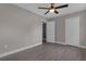 This spacious bedroom features wood-look tile floors, neutral paint, a ceiling fan, and a double closet at 209 Edgewood Dr, Clermont, FL 34711