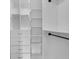 The spacious walk-in closet features built-in shelving, drawers, and hanging rods at 209 Edgewood Dr, Clermont, FL 34711