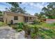Landscaped exterior of the home featuring a screened patio and sidewalk at 209 Edgewood Dr, Clermont, FL 34711