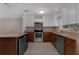 Well-lit kitchen featuring stainless steel appliances, granite countertops, and tiled backsplash at 209 Edgewood Dr, Clermont, FL 34711
