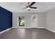 Living room with wood flooring, ceiling fan, natural lighting and neutral paint at 209 Edgewood Dr, Clermont, FL 34711