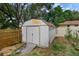 Backyard view of the white shed with a metal ramp in front of the property at 209 Edgewood Dr, Clermont, FL 34711