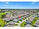 Aerial view of a neighborhood with lush landscaping, lake and golf course at 2160 Biller Cir, The Villages, FL 32163