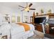 Spacious bedroom with ceiling fan, TV and treadmill at 2160 Biller Cir, The Villages, FL 32163