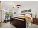 Bright bedroom featuring a large bed, ceiling fan, and a window allowing natural light to filter in at 2160 Biller Cir, The Villages, FL 32163