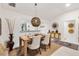 Stylish dining room with modern light fixture and view of the adjacent room through serving hatch at 2160 Biller Cir, The Villages, FL 32163