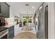 Bright dining area with large window, stylish table, and stainless steel refrigerator at 2160 Biller Cir, The Villages, FL 32163