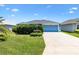Charming single-story home features a well-manicured lawn and an attached two-car garage at 2160 Biller Cir, The Villages, FL 32163