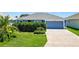 Charming single-story home features a well-manicured lawn and an attached two-car garage at 2160 Biller Cir, The Villages, FL 32163