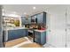 Well-equipped kitchen featuring stainless steel appliances and dark blue cabinets at 2160 Biller Cir, The Villages, FL 32163