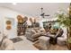 Open-plan living room with light tile flooring, comfortable sofa, and stylish decor at 2160 Biller Cir, The Villages, FL 32163